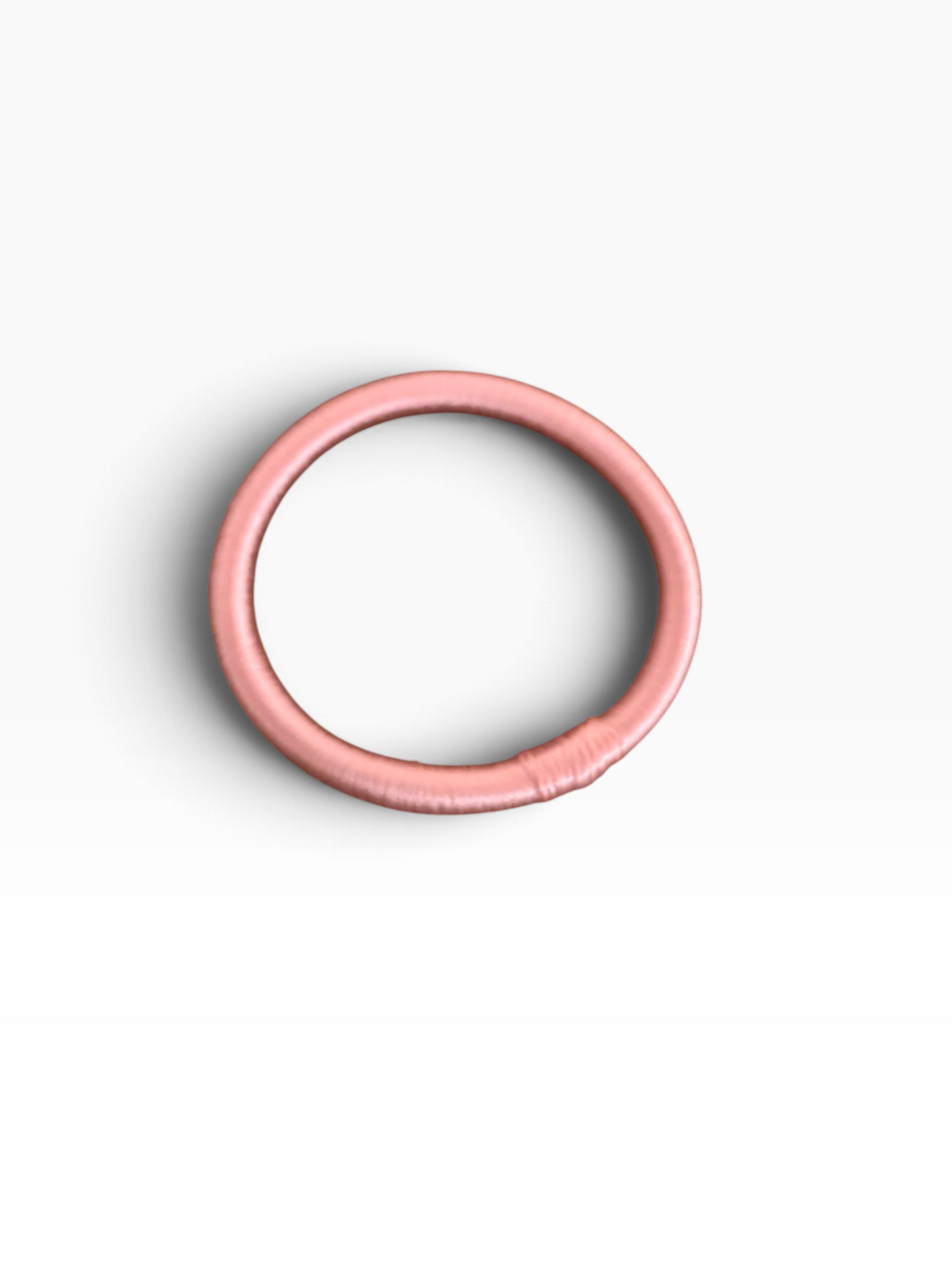 Der LEY! Armreif „Minama – Rosa-Pink“ setzt einen eleganten Farbakzent und windet sich kreisförmig auf weißem Hintergrund.