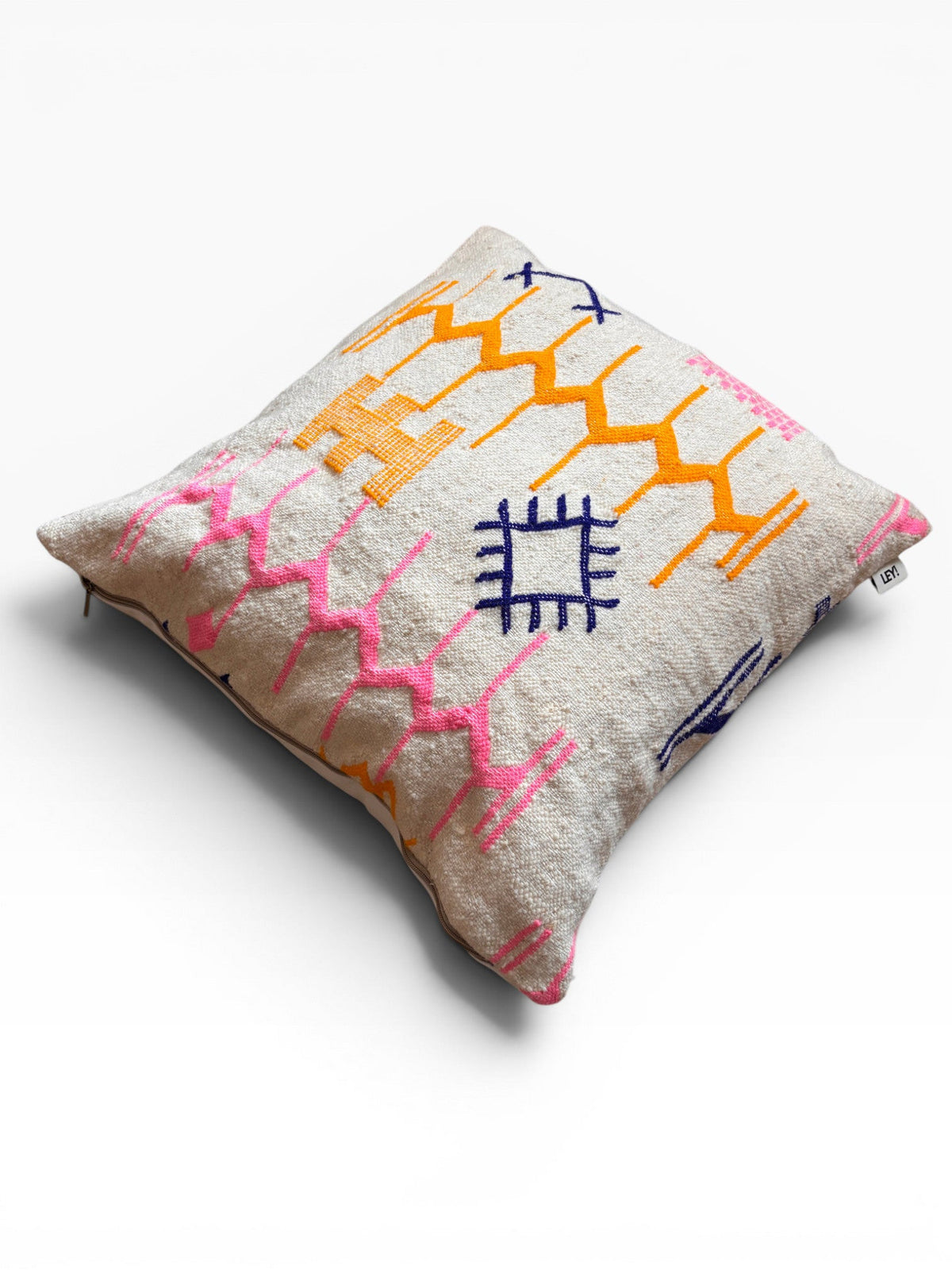LEY! Kissen - Colorful Line - 60 x 60 cm Kissen von LEY! mit rosa, orange & blauen geometrischen Mustern auf beiger Schurwolle.